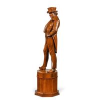 A Victorian carved walnut figure of a fashionable gentleman