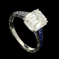 3.20ct emerald-cut diamond ring with calibre-cut sapphire band