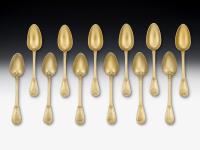 An exceptional set of twelve Silver Gilt Serving Spoons made in London in 1861 by Francis Higgins