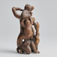 A fascinating Japanese Meiji-era wood-carved Okimono depicting three monkeys and a snake