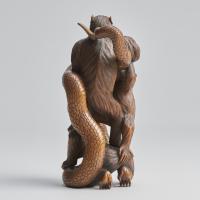 A fascinating Japanese Meiji-era wood-carved Okimono depicting three monkeys and a snake