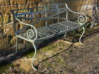 A 19th century wrought iron strap work garden seat