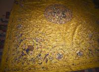 Embroidered bed cover on a yellow silk background