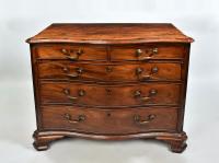 George III mahogany serpentine chest of drawers with crossbanded top, original handles and ogee feet, c.1770