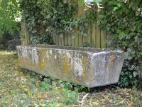 A mid 20th century composition stone trough