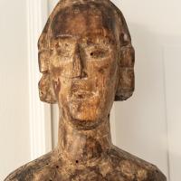 A partial and distressed carved oak figure of a saint - face detail