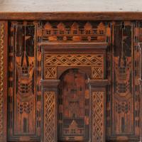 A large antique oak chest with architectural details and inlay, detail of inlay