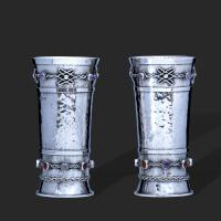 An exceptional pair of arts and crafts gem set silver beakers