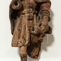 A close up of the bottom half of a 16th century carved figure