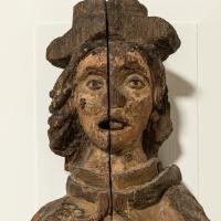A close up of the face of a 16th century carved figure