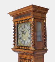 walnut marquetry long-case clock with a bow-fronted glass lenticle