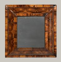 A small oyster olive wood cushion mirror, c.1700