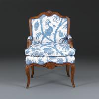 A Pair of Early 19th Century French Walnut Open Armchairs