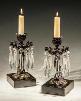 A Pair of Bronzed Dolphin Candlesticks