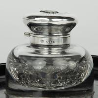 A silver and cut-glass desk set