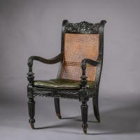 Two Anglo-Indian Carved Ebony Easy Armchairs
