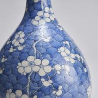 A pair of 19th Century Chinese porcelain bottle vases with plum blossom decoration