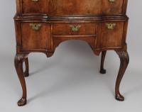 Queen Anne revival walnut chest on stand with a shaped front