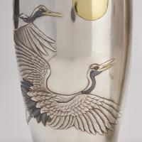A stylish pair of Japanese silver vases depicting flying cranes (Circa 1915)