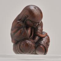 An attractive Japanese late 19th Century wood-carved Netsuke depicting a Shojo