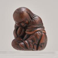 An attractive Japanese late 19th Century wood-carved Netsuke depicting a Shojo