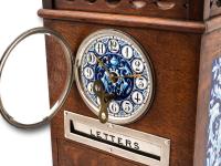 View with the clock glass hinged open and the winding key inserted