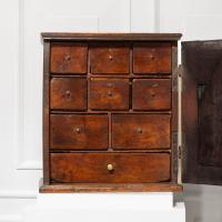 An early 18th century fruitwood and elm table-top spice cupboard, English or Welsh, circa 1700-20