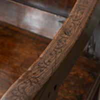 A rare Charles II commemorative joined oak panel-back open armchair, initialled and dated