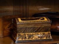 Overview of the tunbridge ware tea caddy in a decorative collectors setting